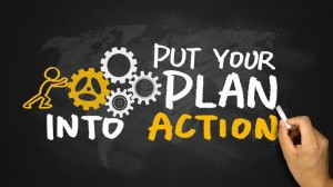 put your plan into action handwritten on blackboard